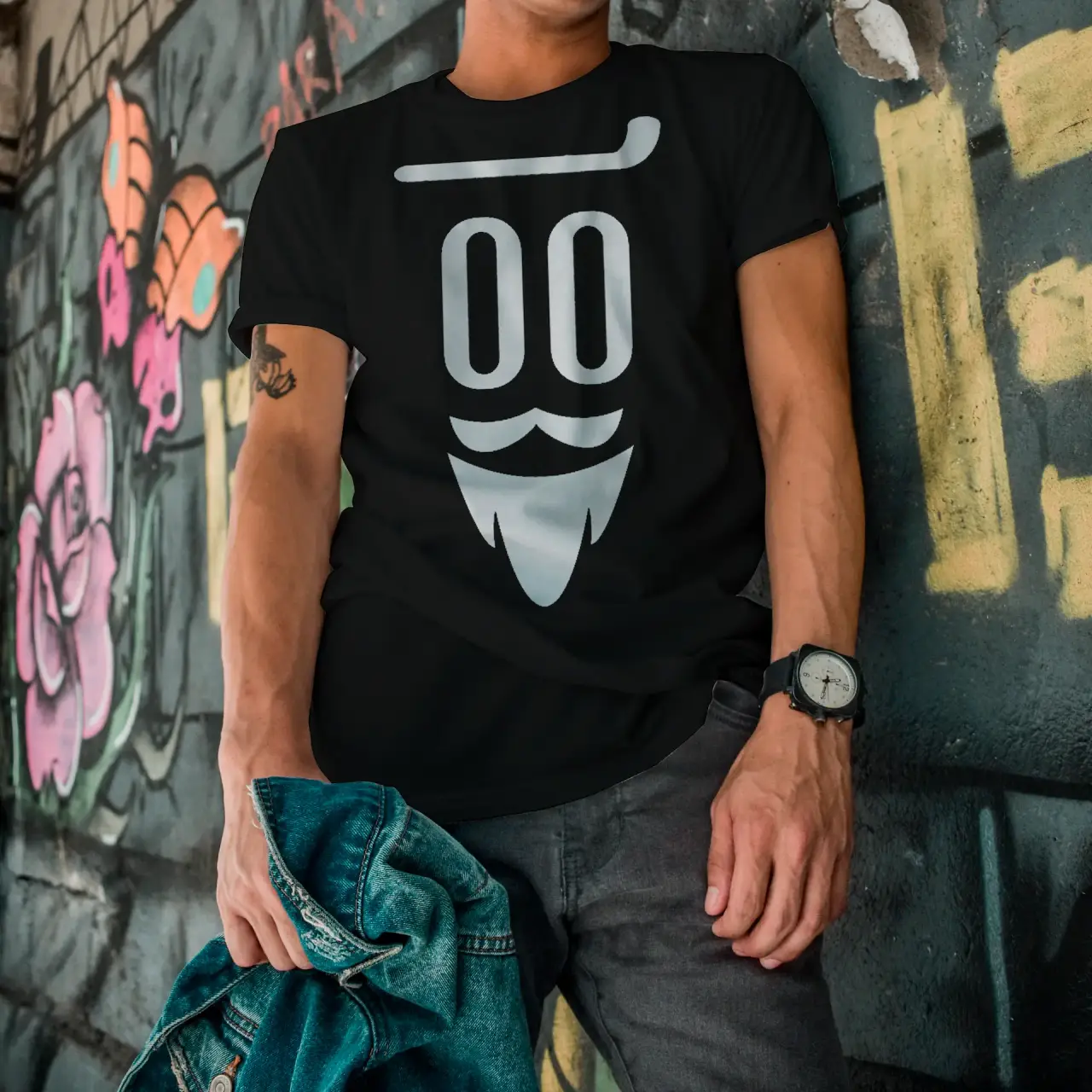 A man wearing a Borodach-branded shirt and a pair of jeans.