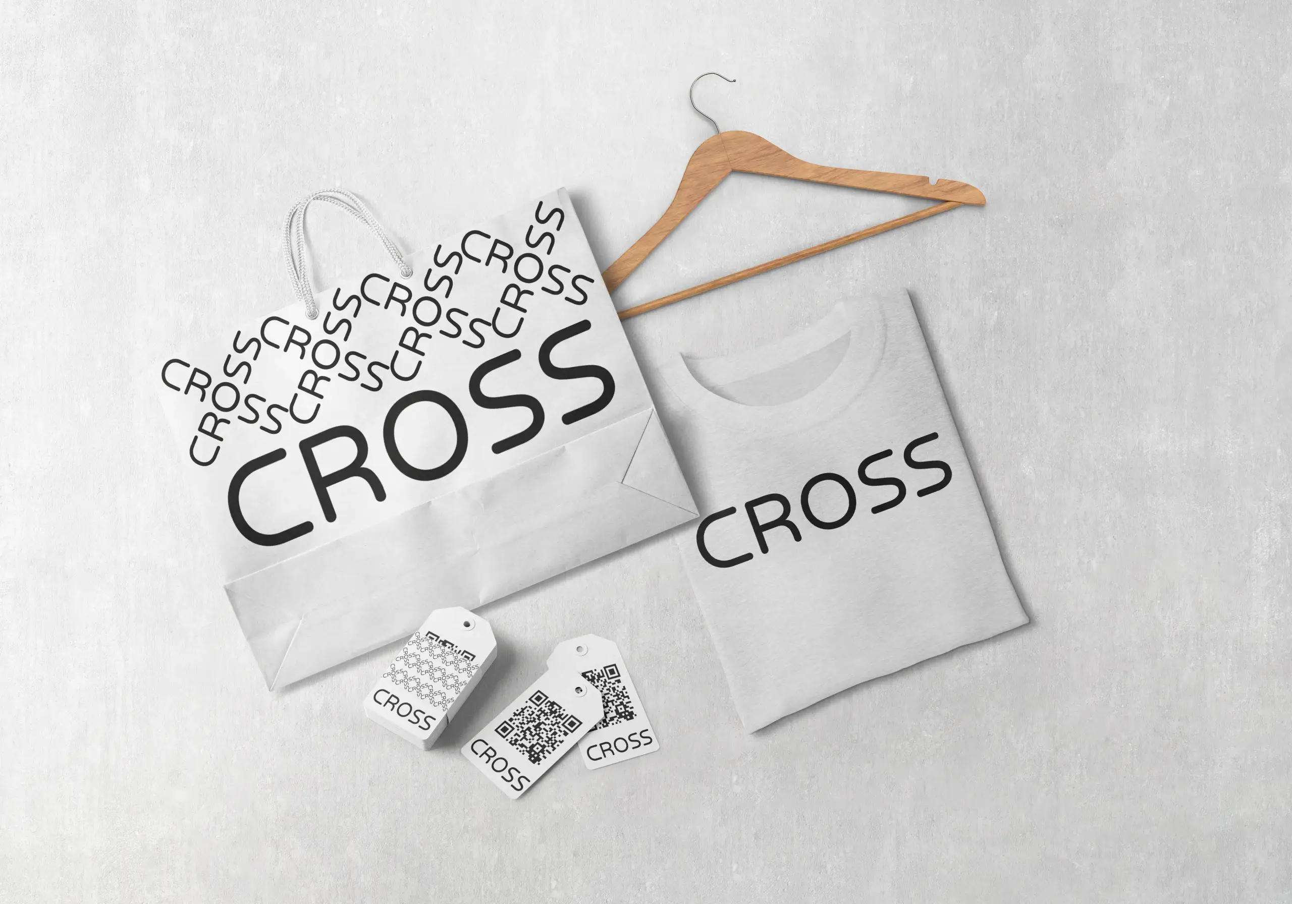 A shirt and a shopping bag with Cross branding.